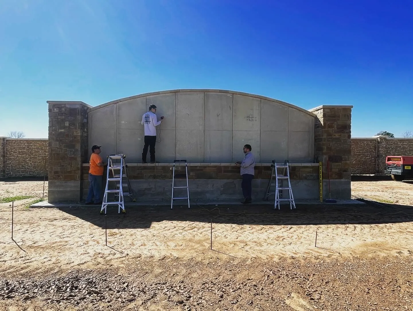 Restore Texas volunteers rebuilding a community stone monument
